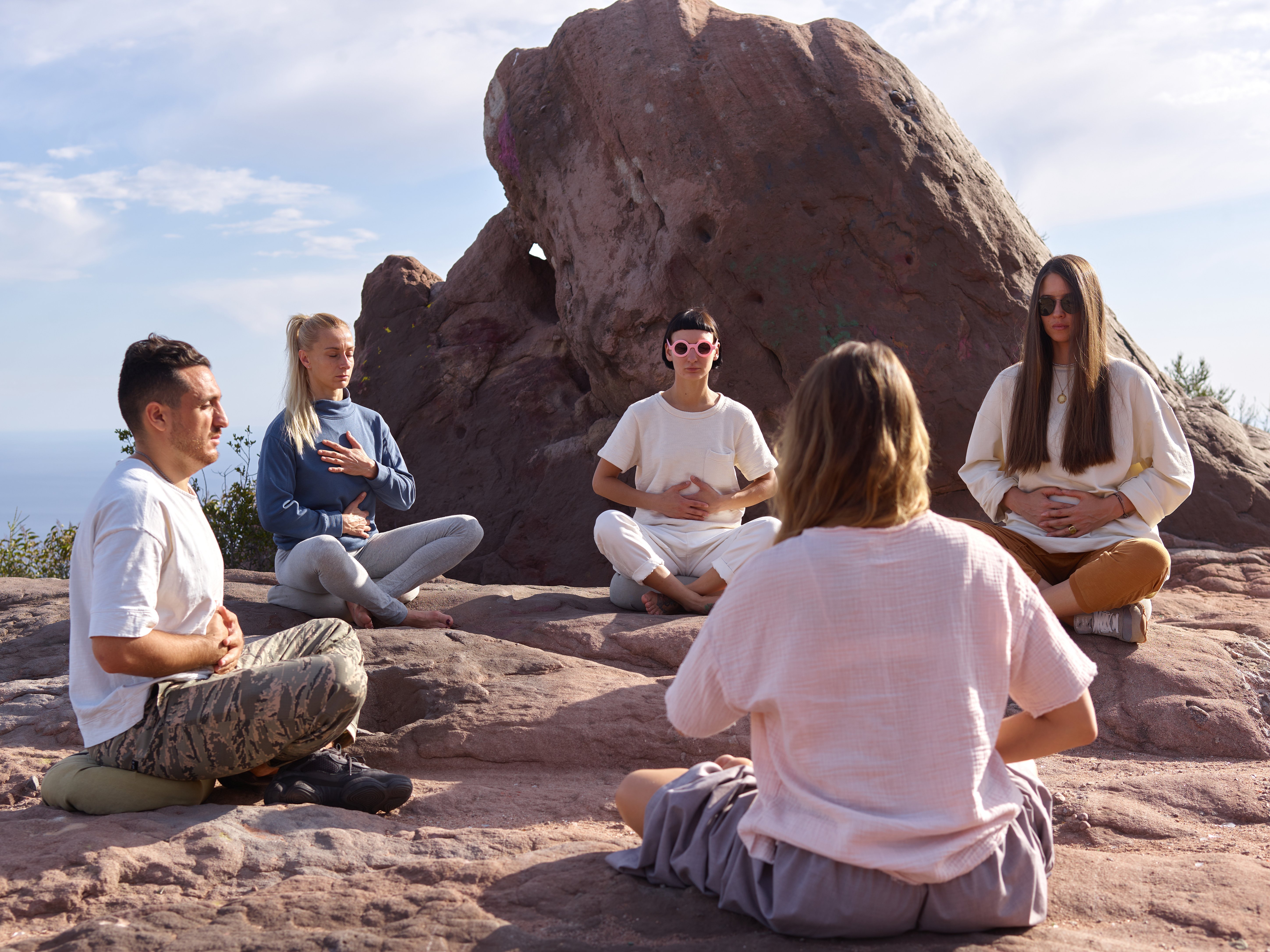 Group of People Sitting in a Circle with Hands on Belly 